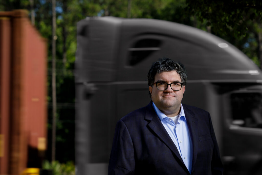 Chuck Giroux editorial portrait beside shipping containers, Wando terminal Charleston