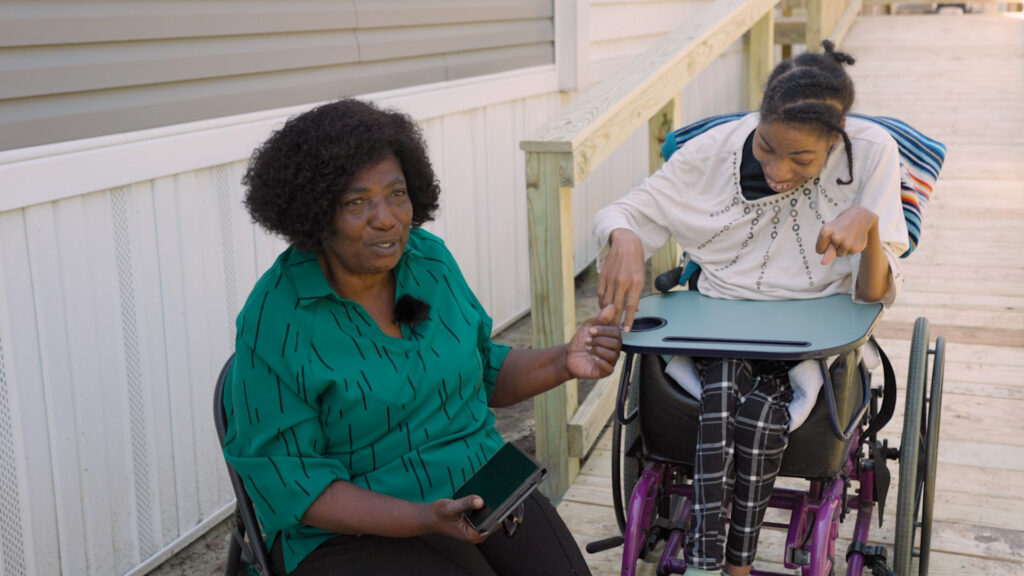Laura Campbell during her interview, alongside her niece, sitting in front of the new wheelchair ramp