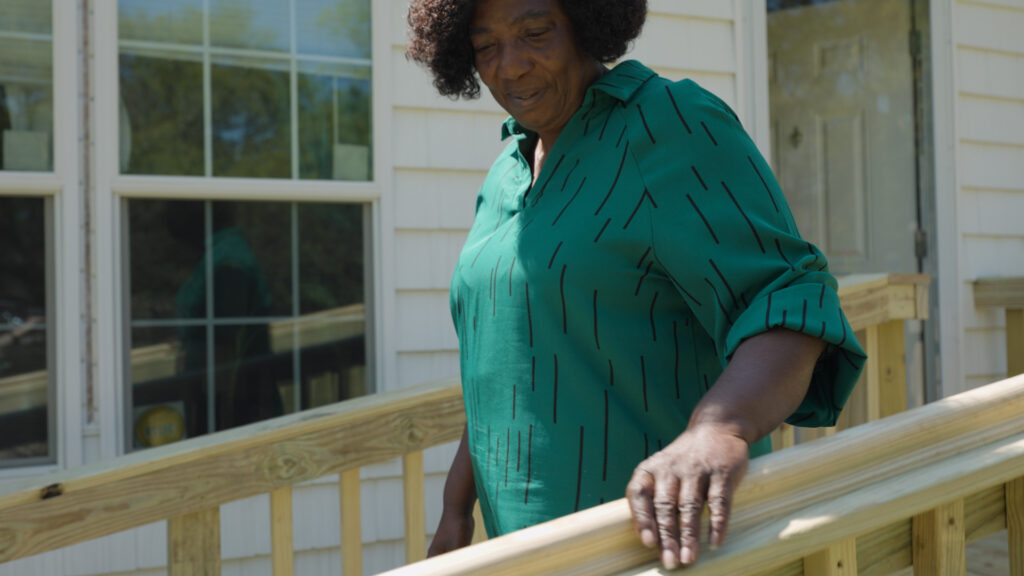 Dolores Campbell admiring the finished wheelchair ramp construction
